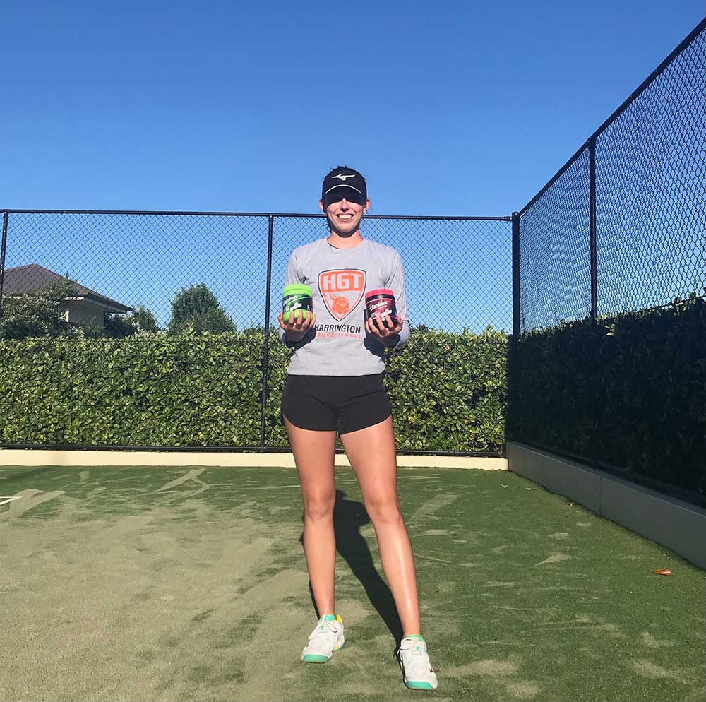 Tennis player Kelsey Lewis holding Staminade sports drink tubs